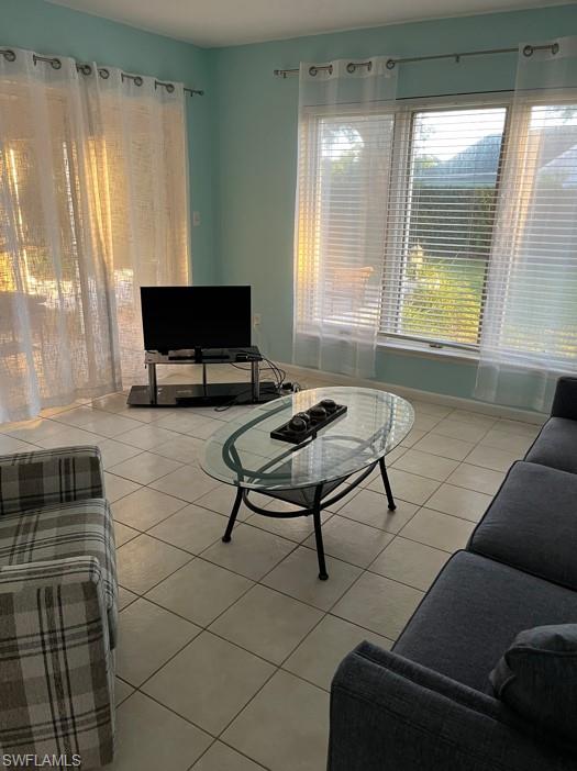 240 Palm River Boulevard, Unit C102 Naples, FL 34110 - Photo 7 of 17 a living room with a couch and a table