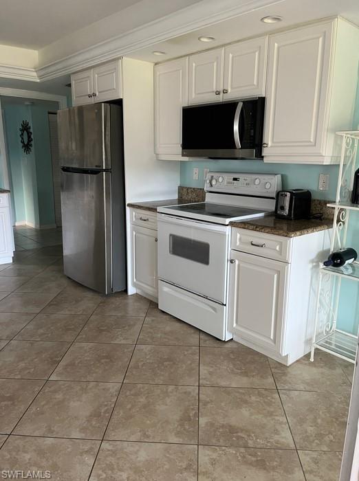 240 Palm River Boulevard, Unit C102 Naples, FL 34110 - Photo 10 of 17 a kitchen with a refrigerator stove and microwave