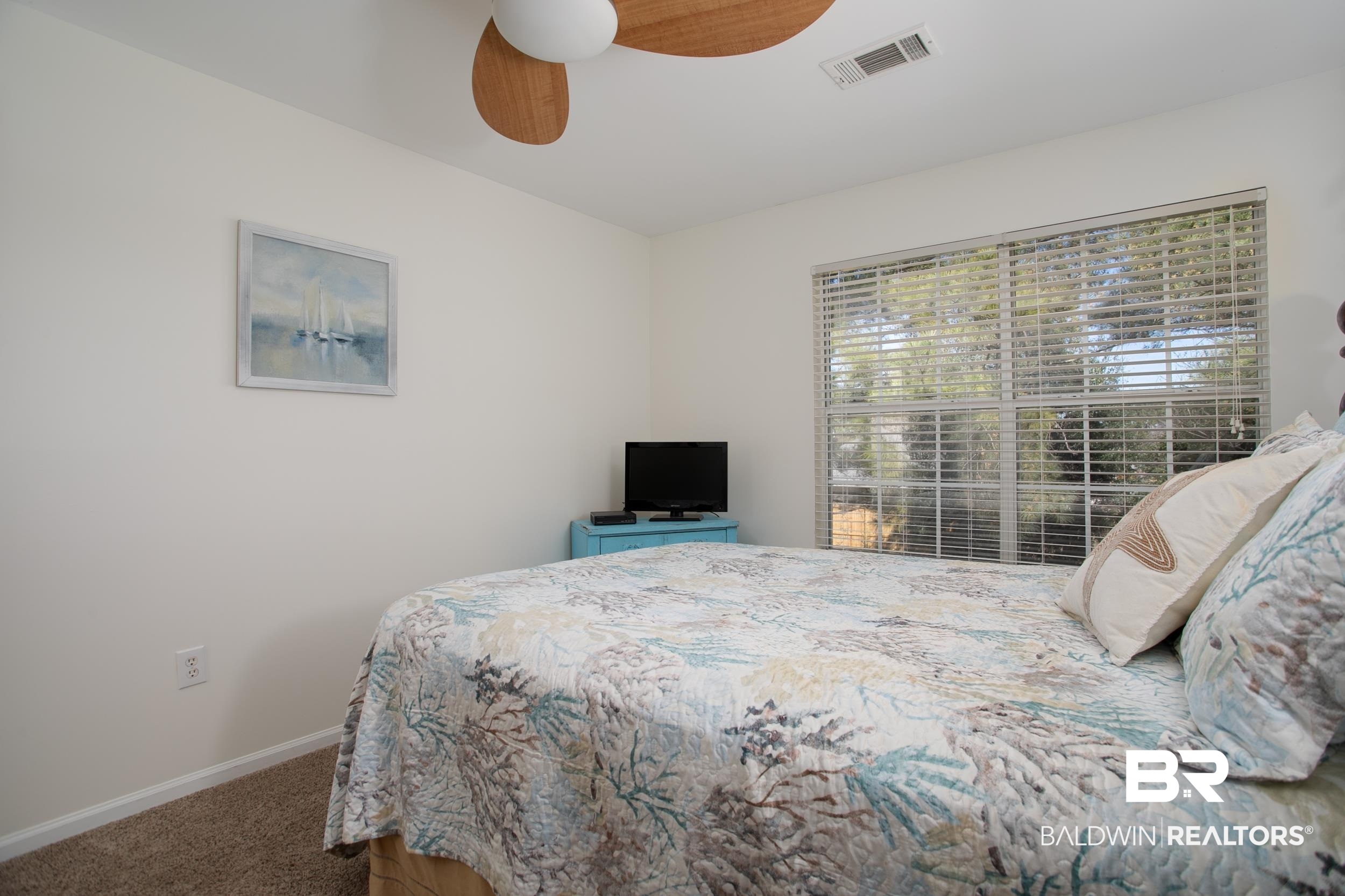 1517 Regency Road, Unit 33 Gulf Shores, AL 36542 - Photo 19 of 29 Bedroom with visible vents, baseboards, carpet, and a ceiling fan