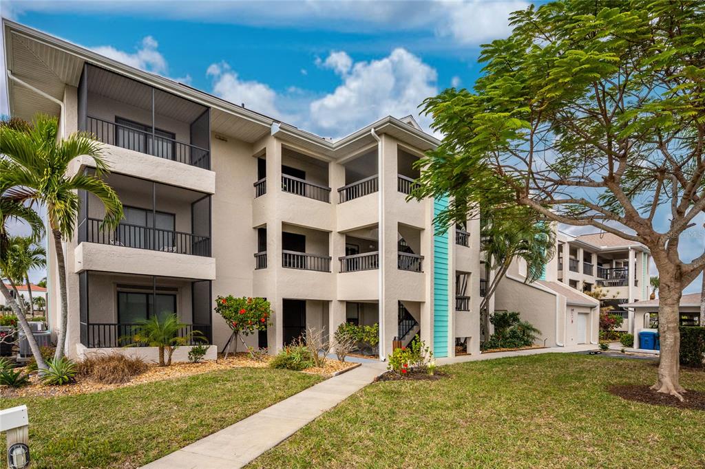 3245 Sugarloaf Key Road, Unit 24C Punta Gorda, FL 33955 - Photo 4 of 8 a front view of a building with a garden
