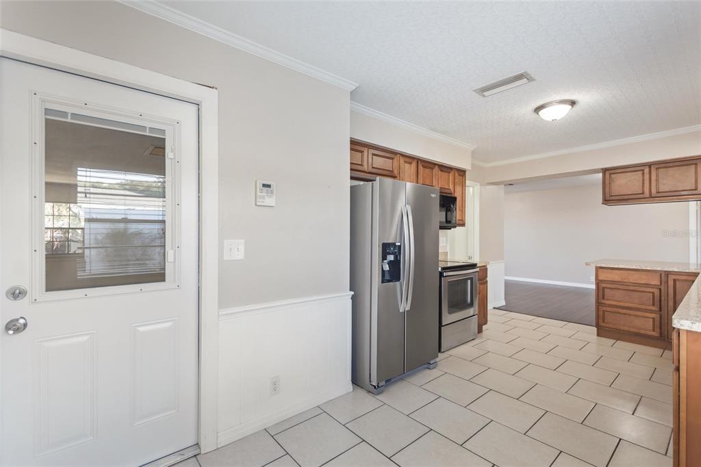 130 Audubon Road Winter Haven, FL 33884 - Photo 11 of 46 a kitchen with stainless steel appliances a refrigerator and a stove top oven
