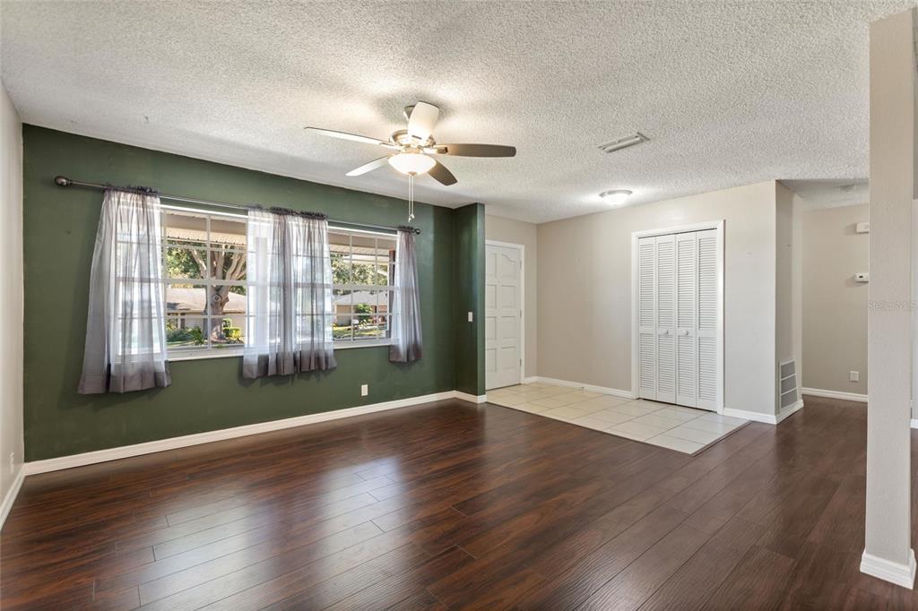 130 Audubon Road Winter Haven, FL 33884 - Photo 14 of 46 a view of an empty room with wooden floor and a window