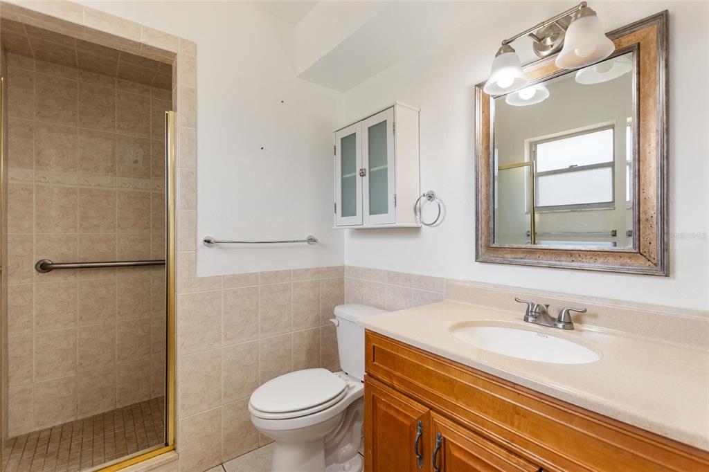 130 Audubon Road Winter Haven, FL 33884 - Photo 24 of 46 a bathroom with a granite countertop sink toilet and shower