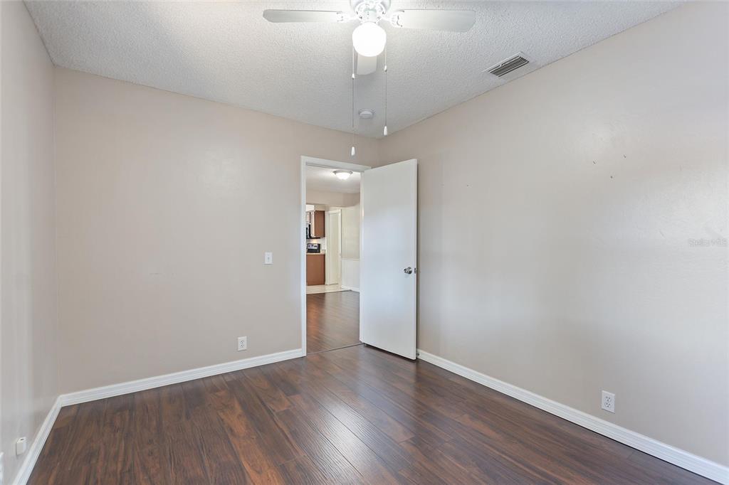 130 Audubon Road Winter Haven, FL 33884 - Photo 27 of 46 a view of a room with wooden floor and a ceiling fan