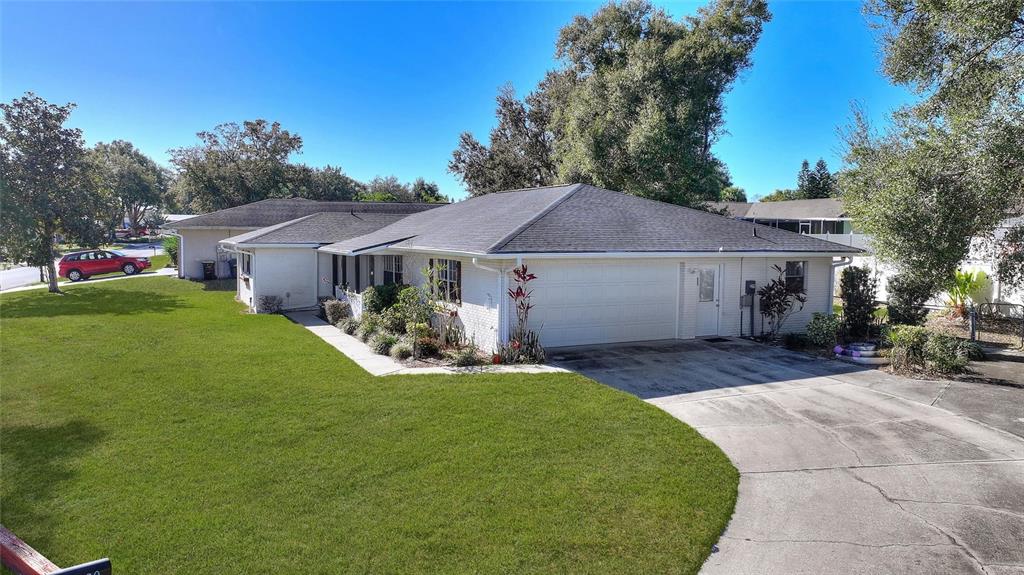 130 Audubon Road Winter Haven, FL 33884 - Photo 35 of 46 a front view of a house with a yard and garage
