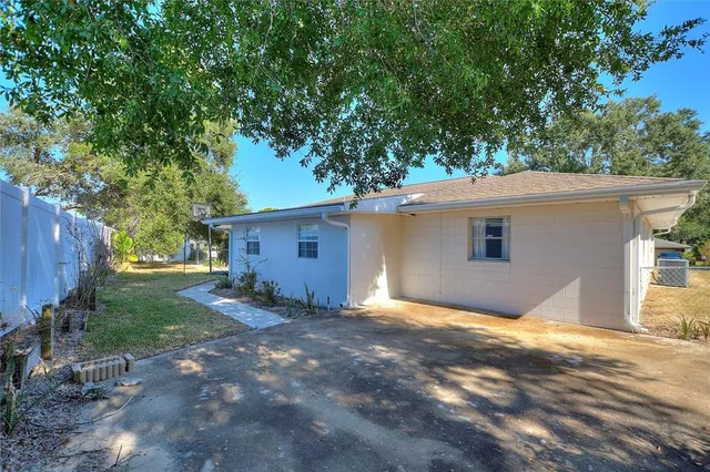 an aerial view of a houses with a swimming pool