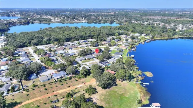 an aerial view of residential houses with outdoor space and swimming pool