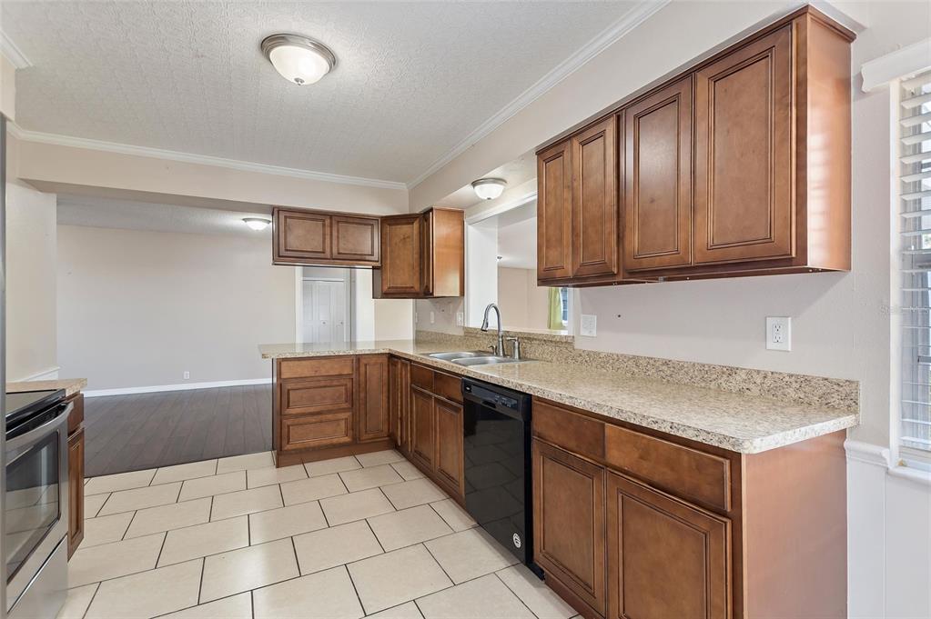 130 Audubon Road Winter Haven, FL 33884 - Photo 7 of 46 a kitchen with stainless steel appliances granite countertop a sink stove and cabinets