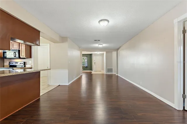 a view of a kitchen with a sink and wooden floor