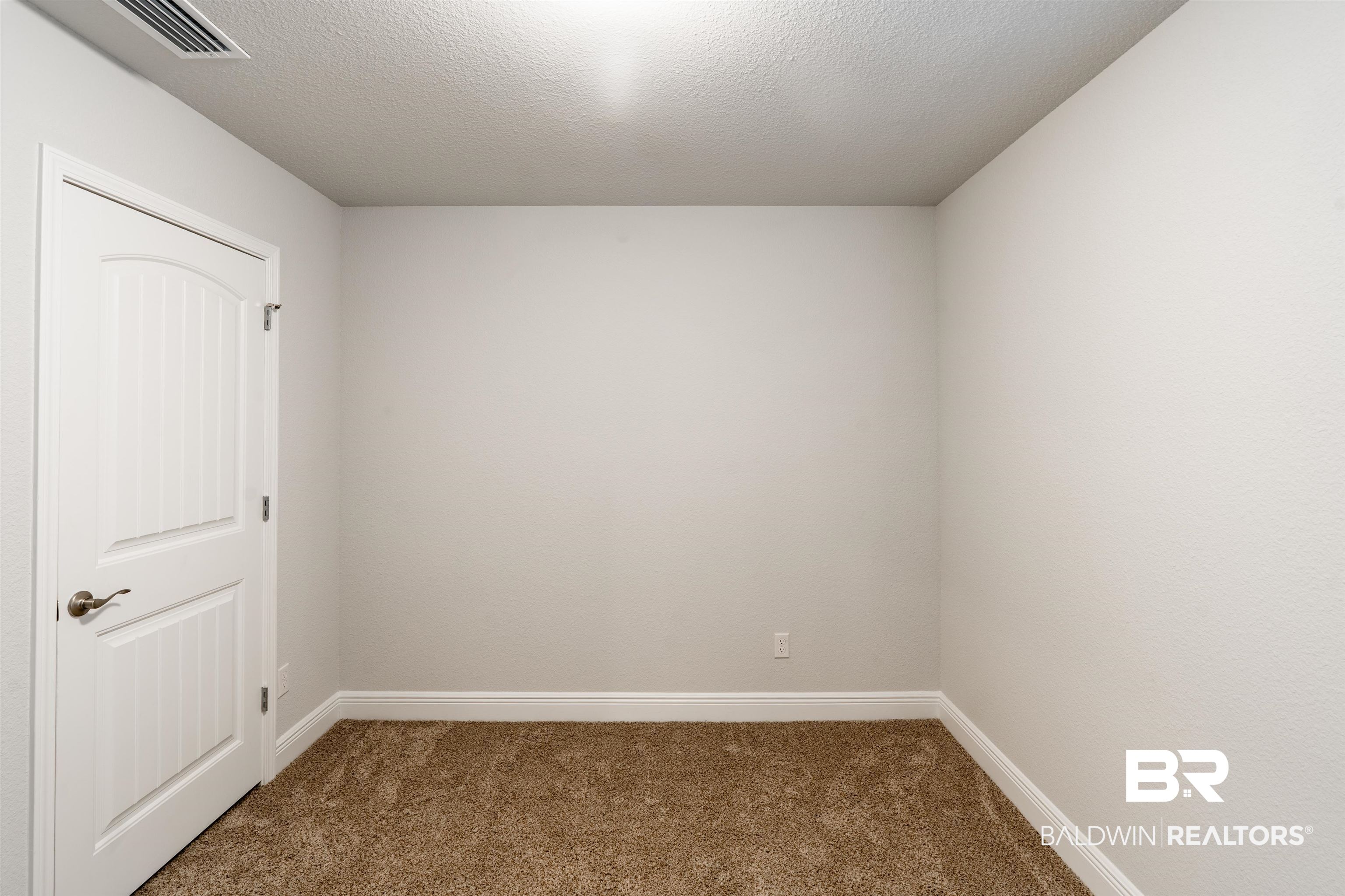 1906 Stonepine Drive South Semmes, AL 36575 - Photo 11 of 30 Unfurnished room with dark colored carpet and a textured ceiling