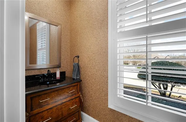 a bathroom with a sink a vanity and a mirror
