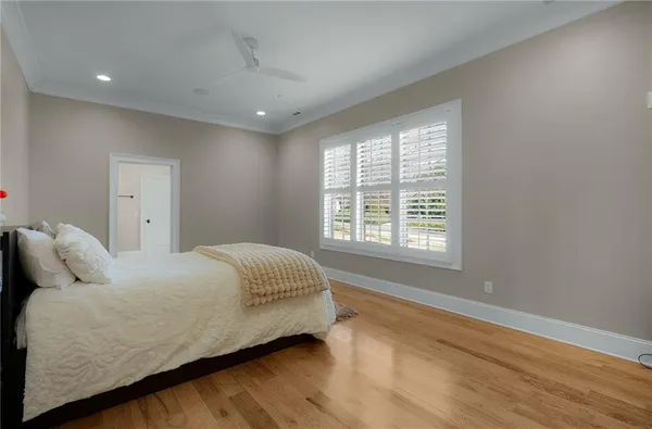 a living room with furniture a wooden floor and kitchen view