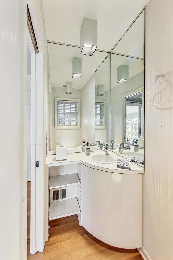 765 Walden Road Winnetka, IL 60093 - Photo 16 of 40 a view of a bathroom with sink and mirror