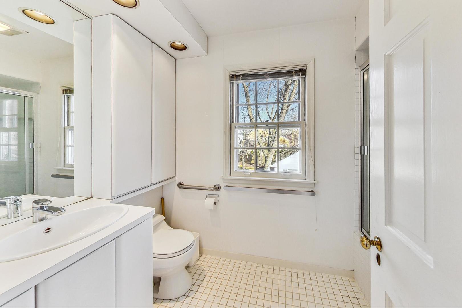 765 Walden Road Winnetka, IL 60093 - Photo 19 of 40 a bathroom with a sink toilet and shower