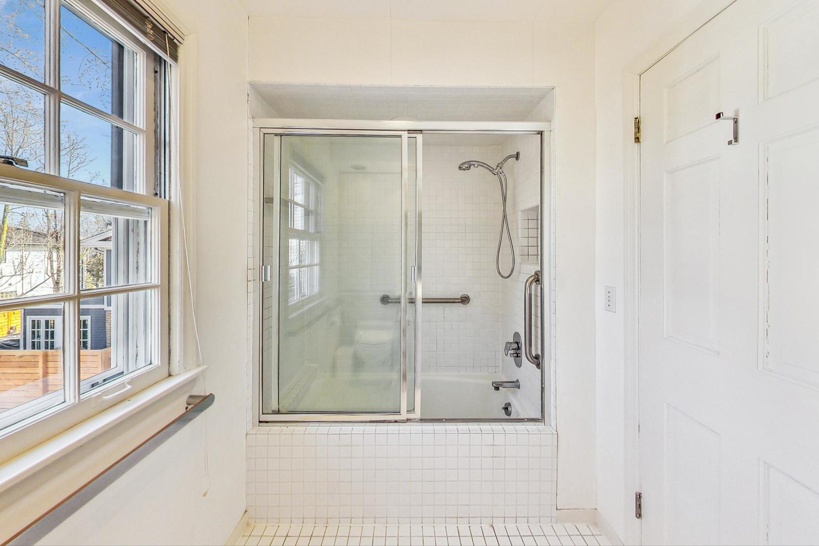 765 Walden Road Winnetka, IL 60093 - Photo 20 of 40 a view of a bathroom with a glass door shower and a sink