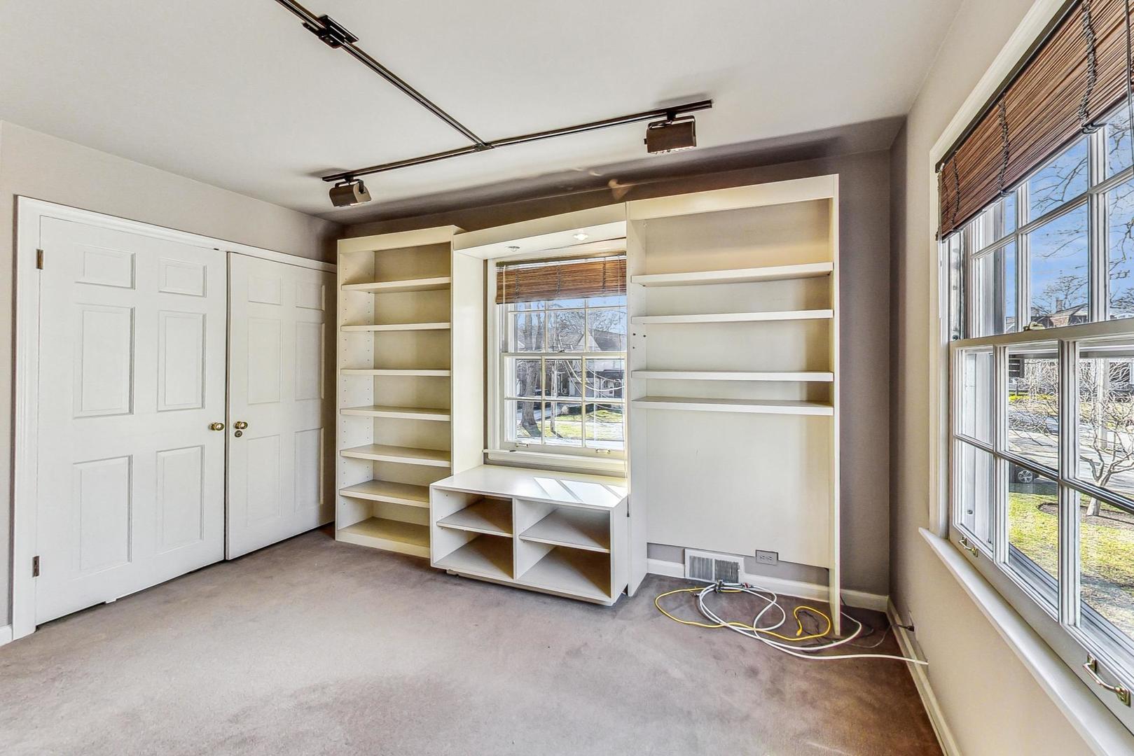 765 Walden Road Winnetka, IL 60093 - Photo 26 of 40 a view of an empty room with a fireplace and a window