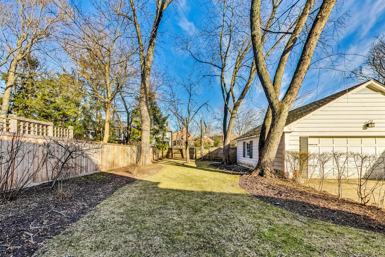 765 Walden Road Winnetka, IL 60093 - Photo 38 of 40 a view of a backyard with wooden fence