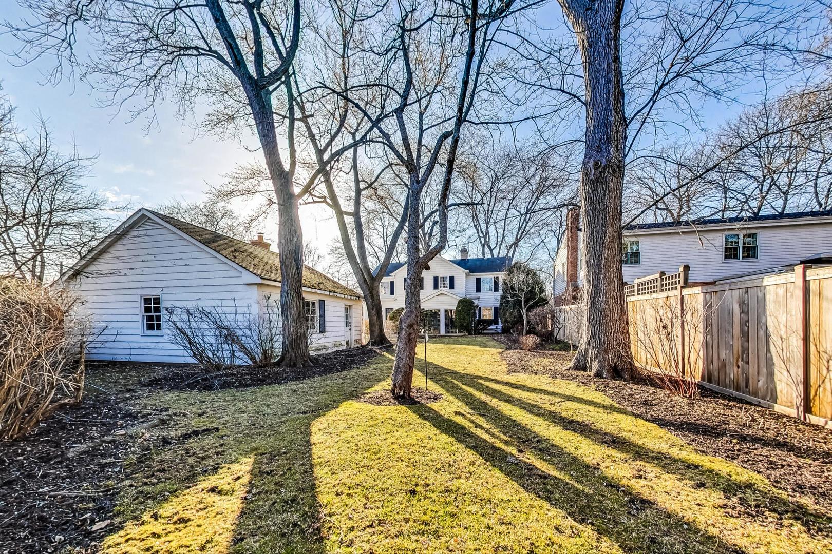 765 Walden Road Winnetka, IL 60093 - Photo 39 of 40 a view of a house with a yard covered in snow