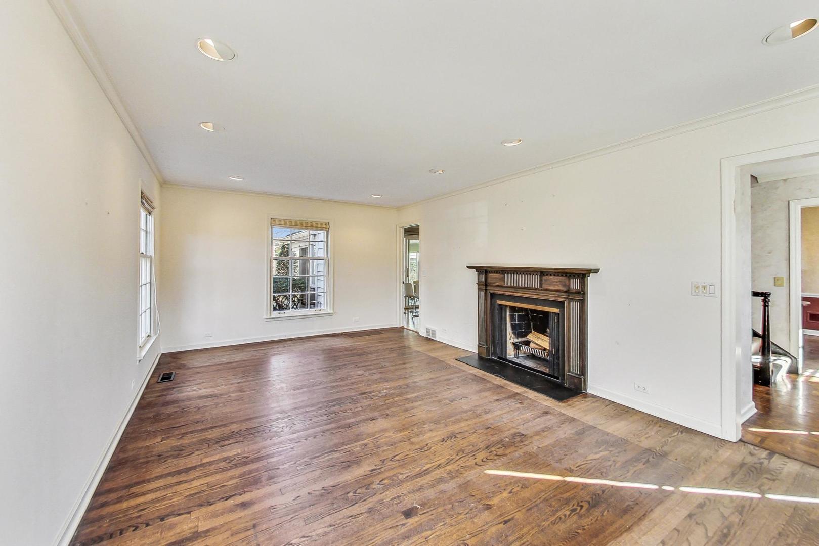 765 Walden Road Winnetka, IL 60093 - Photo 5 of 40 a view of an empty room with a fireplace and a window