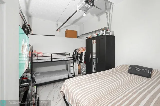 a bedroom with a bed and ceiling fan