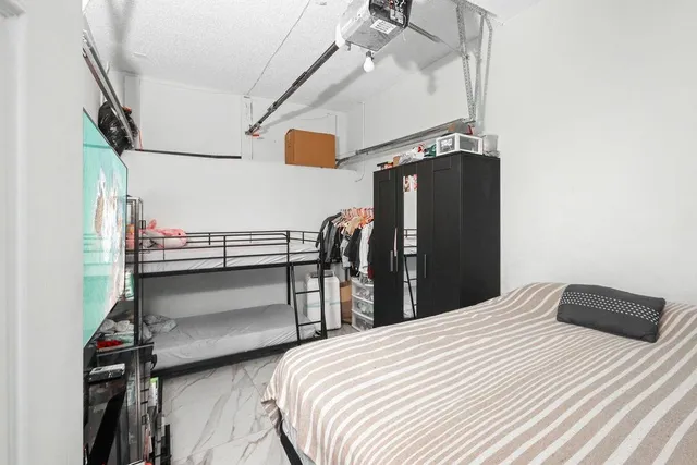 a bedroom with a bed and ceiling fan