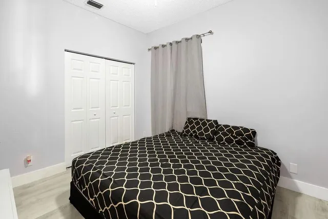 a bedroom with a black and white wall