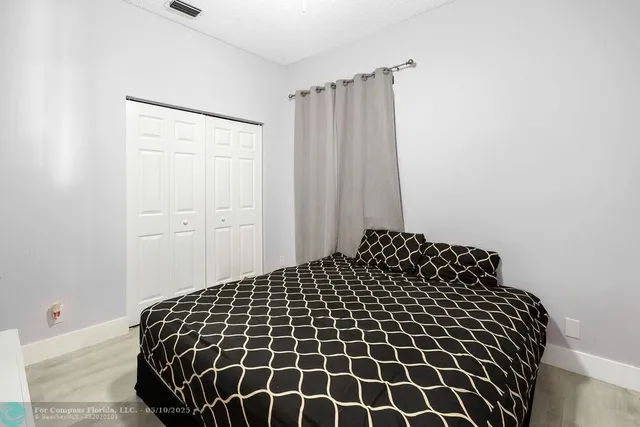 a bedroom with a black and white wall