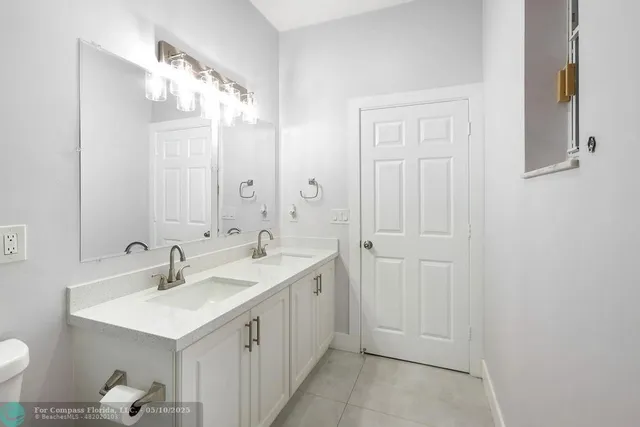a bathroom with 2 sink and a mirror