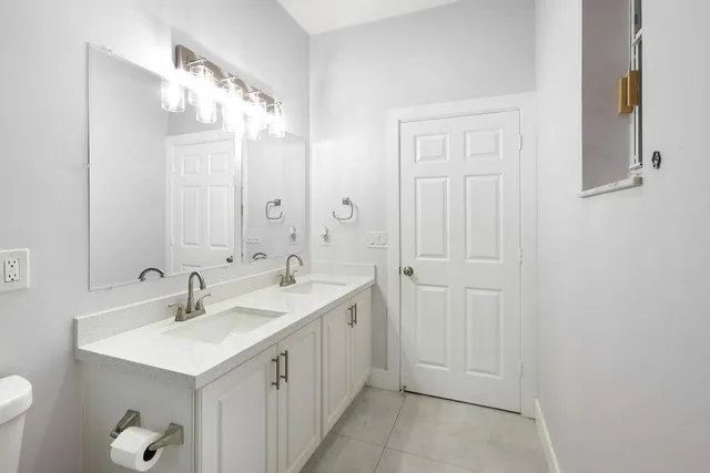 a bathroom with 2 sink and a mirror