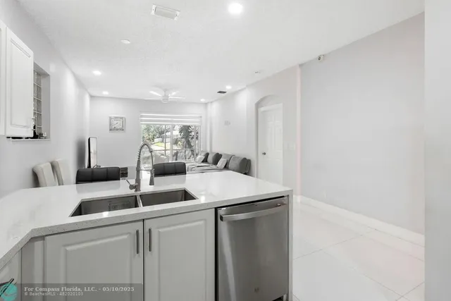 a kitchen with a sink and white cabinets