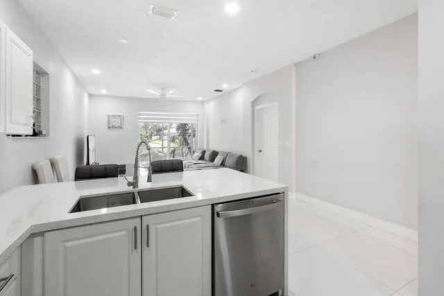 a kitchen with a sink and white cabinets