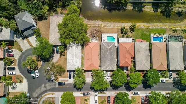 an aerial view of residential houses with outdoor space and swimming pool