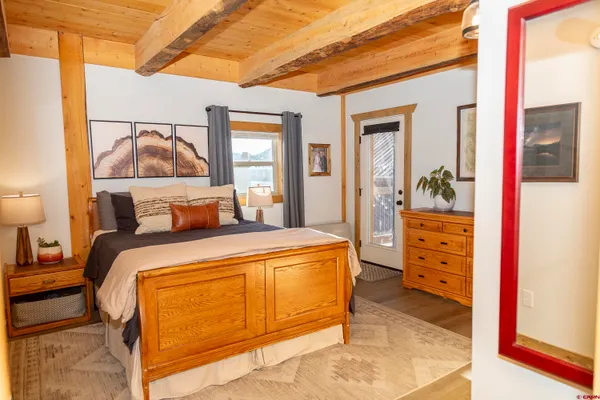 a bedroom with a bed and flat screen tv