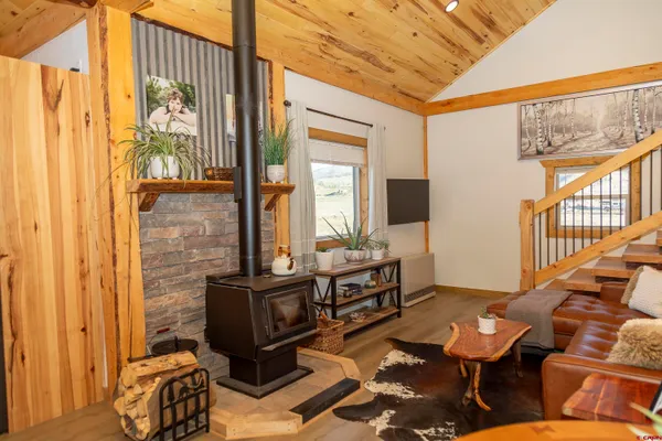 a living room with furniture windows and wooden floor