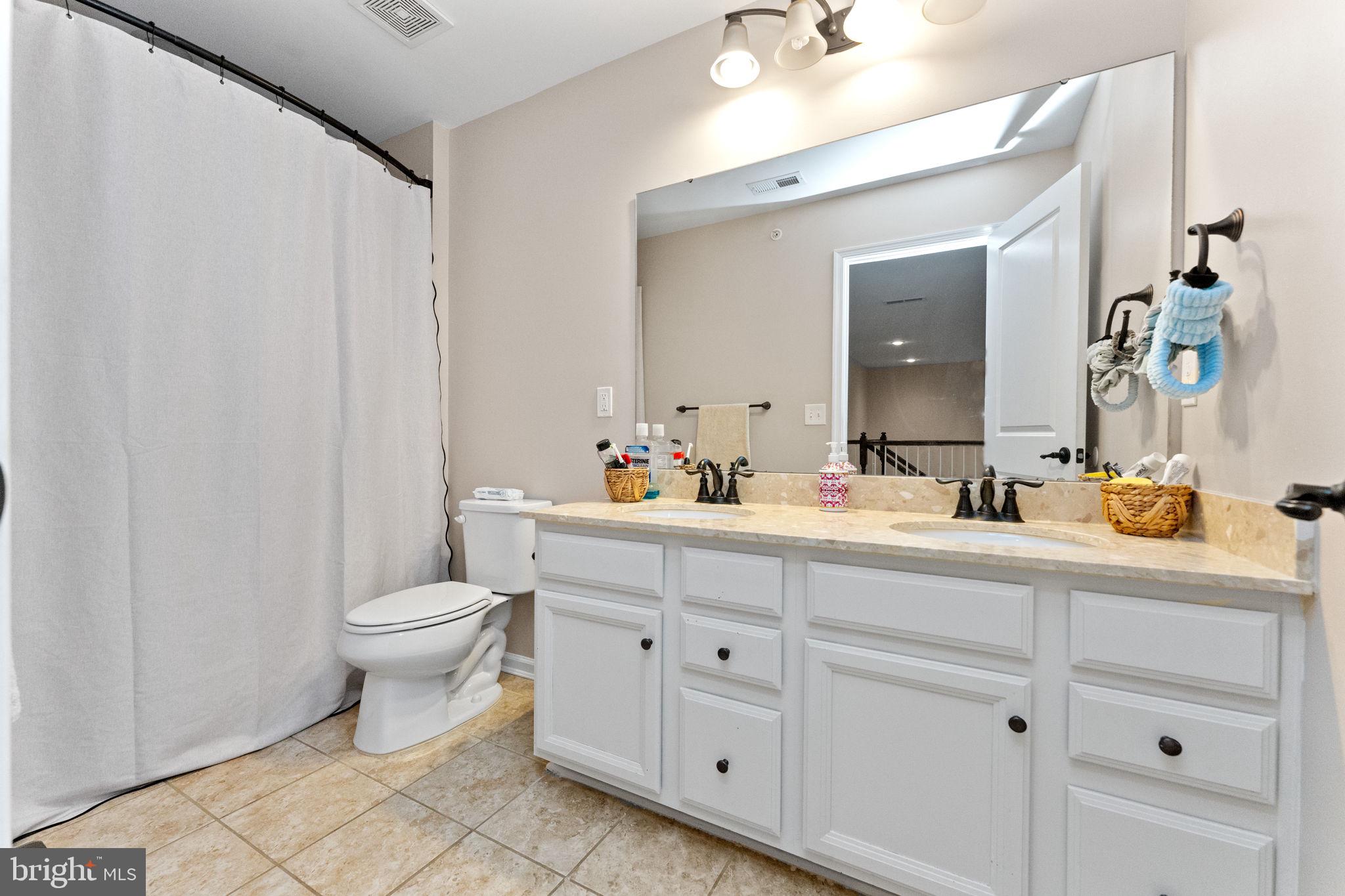 870 Reynards Run Blue Bell, PA 19422 - Photo 24 of 30 a spacious bathroom with a toilet sink and mirror