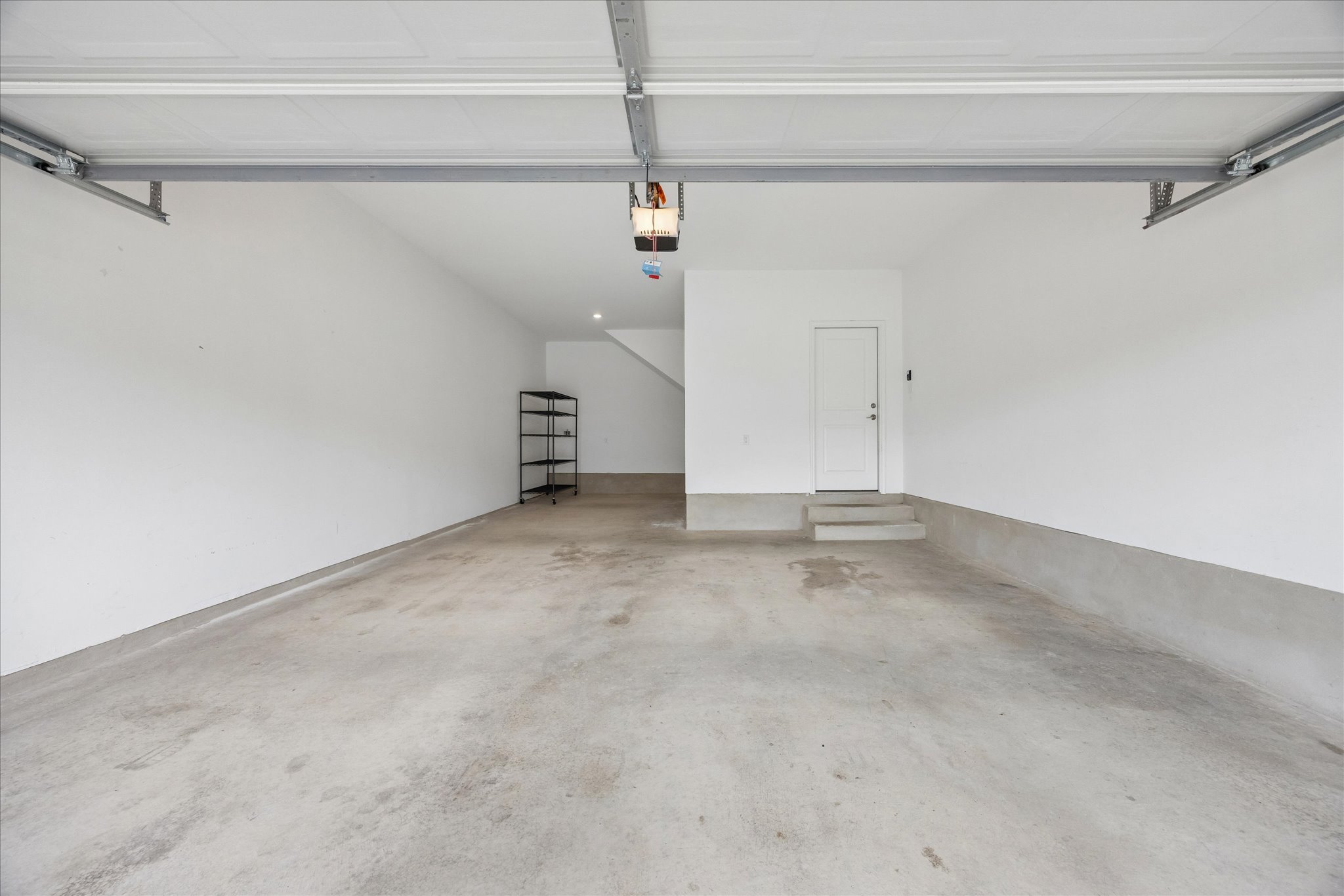 6407 Rounded Pebble Lane Buda, TX 78610 - Photo 26 of 32 Secure parking and extra storage space in this well-maintained garage.