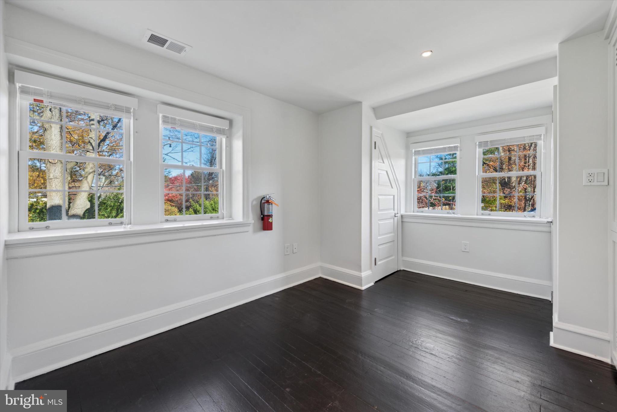 767-769 Newtown Road Villanova, PA 19085 - Photo 19 of 26 a view of an empty room with wooden floor and a window