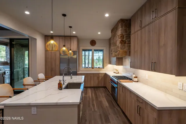 a large white kitchen with a large window