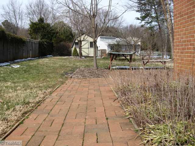 1908 Three Meadows Road Greensboro, NC 27455 - Photo 11 of 15 Landscaping. Brick walk-way leading to the brick patio