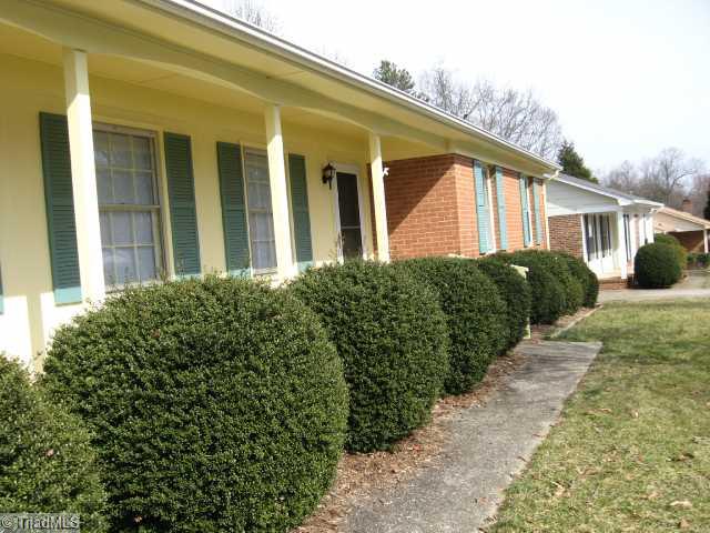 1908 Three Meadows Road Greensboro, NC 27455 - Photo 10 of 15 Exterior Front. Mature boxwoods line the front of the home