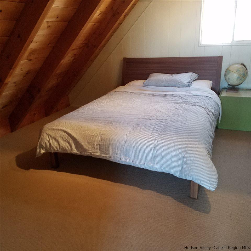 178 Upper Highland Circle Roxbury, NY 12421 - Photo 13 of 35 a bed sitting in a bedroom next to a window