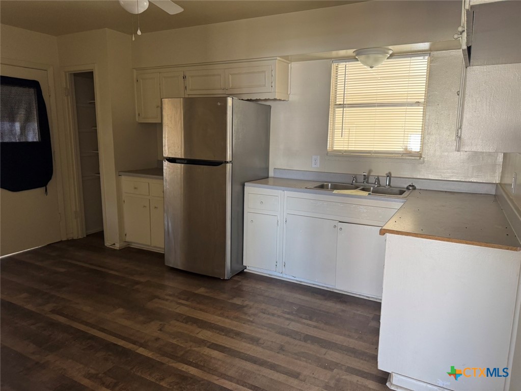 904 Houston Street Killeen, TX 76541 - Photo 11 of 17 a kitchen with a refrigerator sink and cabinets