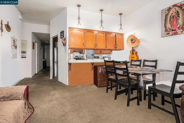 a kitchen with a stove and a refrigerator