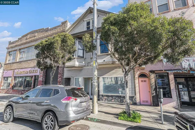 a front view of a residential apartment building with a yard