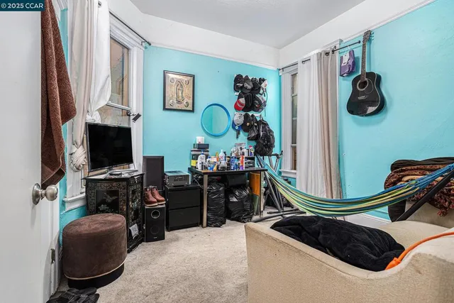 a bedroom with bed and a flat tv screen