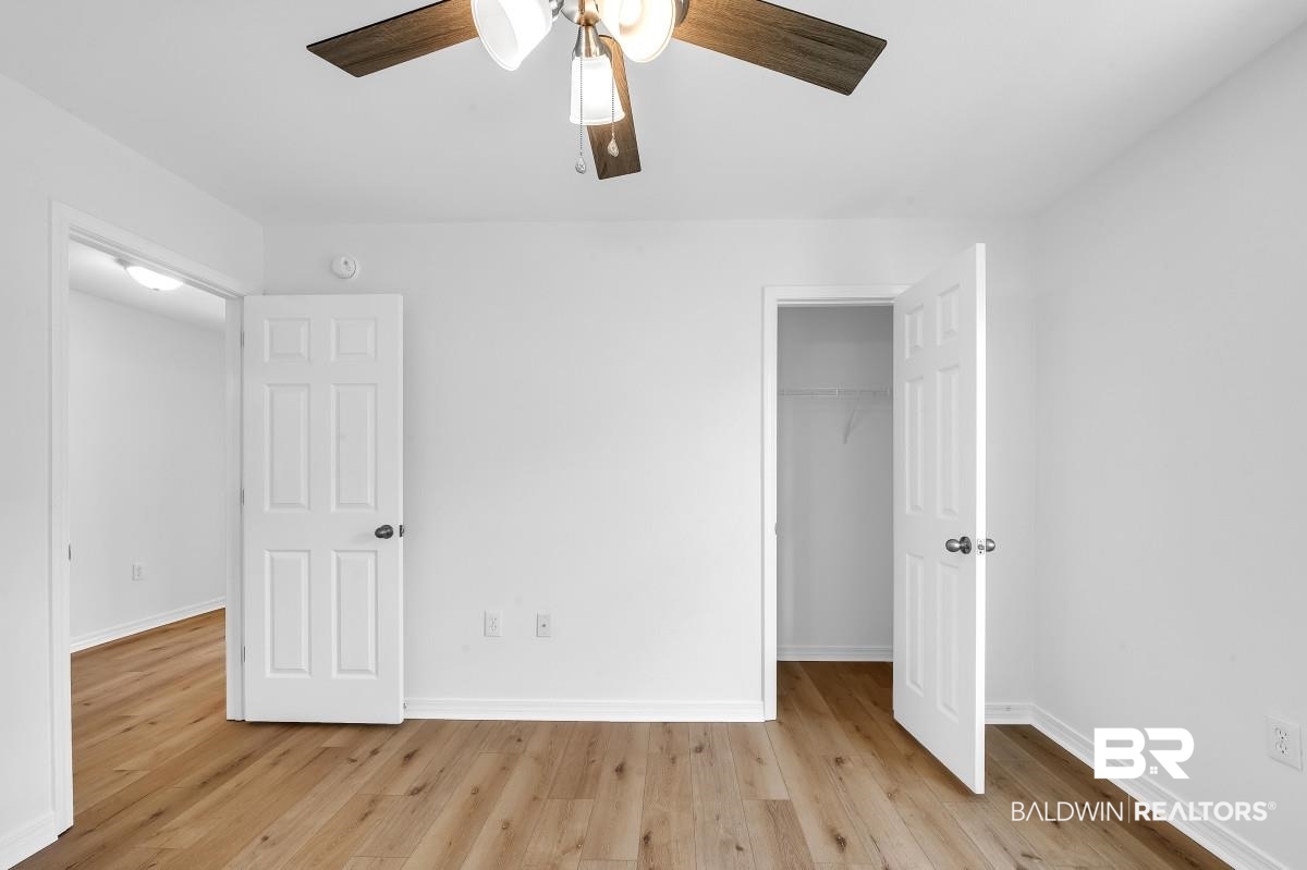 16927 Sugar Loop Foley, AL 36535 - Photo 33 of 50 Unfurnished bedroom with a closet, wood finished floors, and ceiling fan