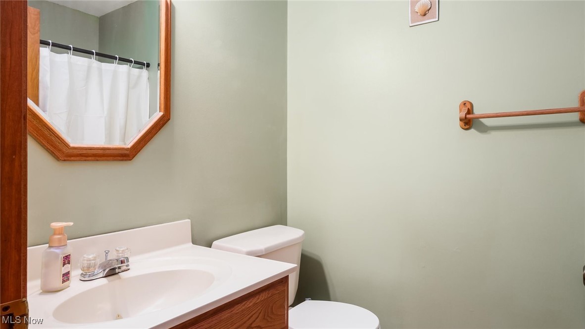 9910 Matchett Road Norwich, OH 43767 - Photo 22 of 48 Bathroom with vanity and a shower with shower curtain