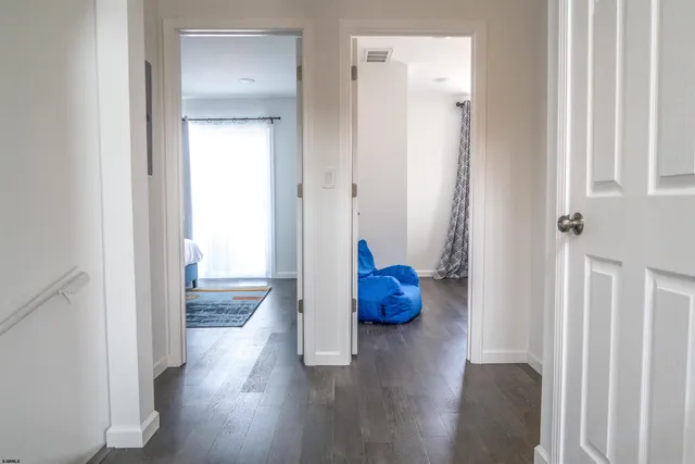 a view of an empty room and wooden floor