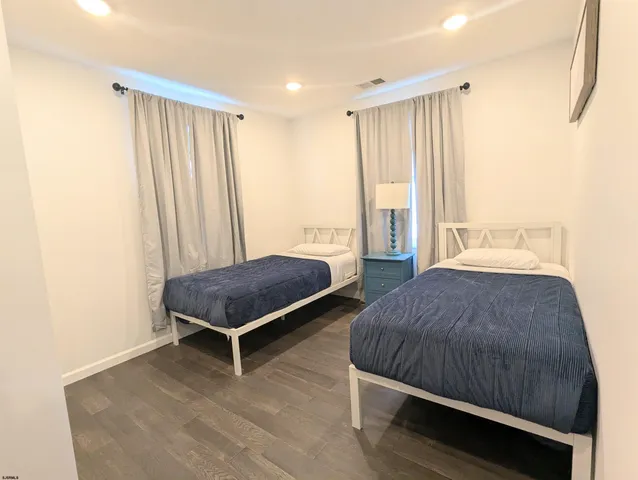 a spacious bedroom with a bed and window