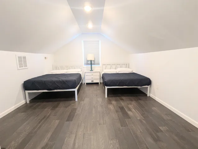a living room with a bed furniture and a potted plant